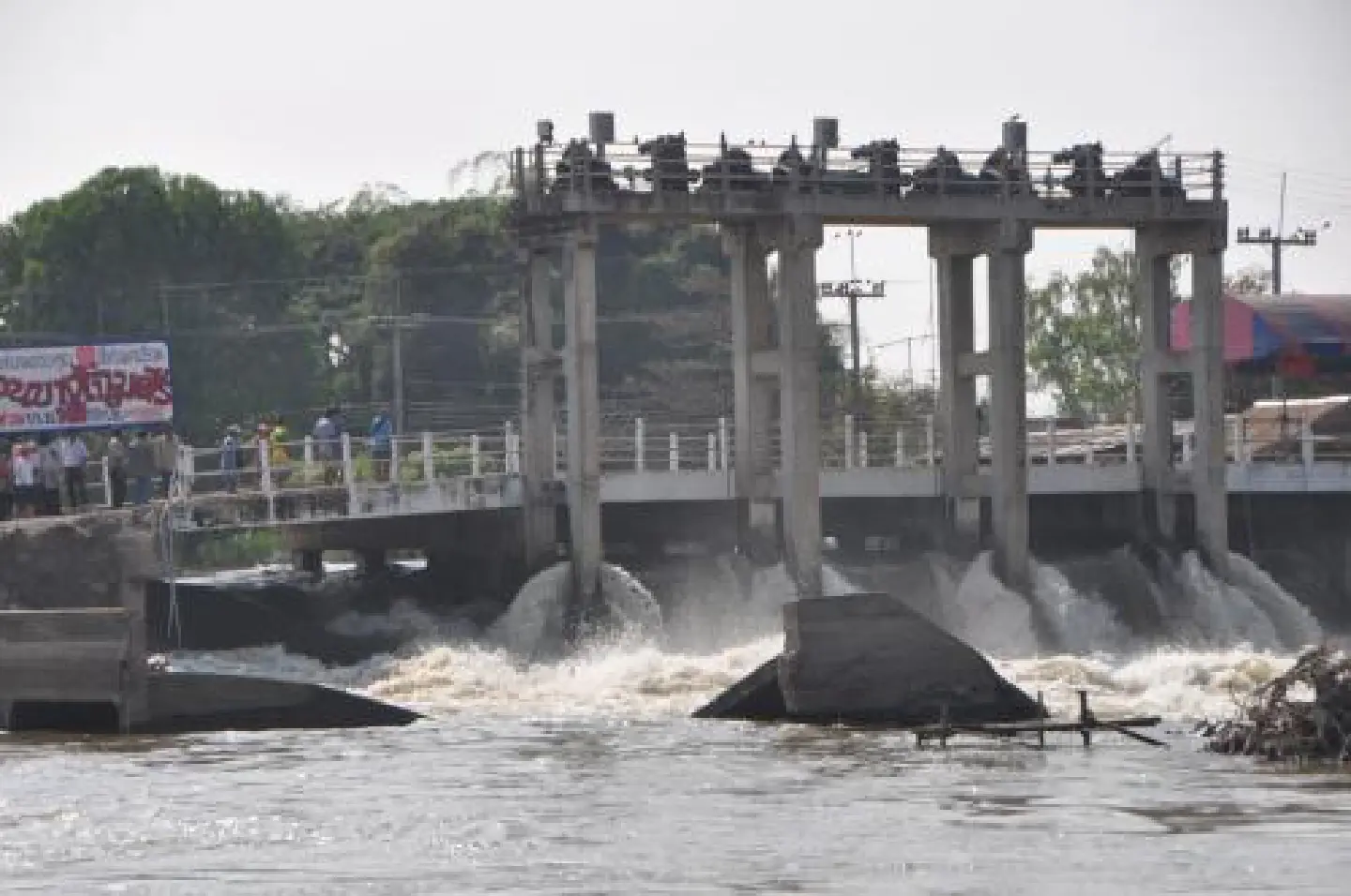 As sluice gate is fixed, a canal levee is torn down As sluice gate is fixed, a canal levee is torn down