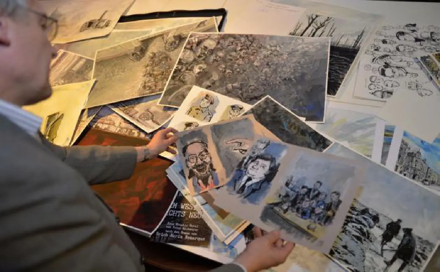 Eickmeyer holds a proof copy of his rendition of "All Quiet". That war, that book, a century on Eickmeyer holds a proof copy of his rendition of "All Quiet". That war, that book, a century on