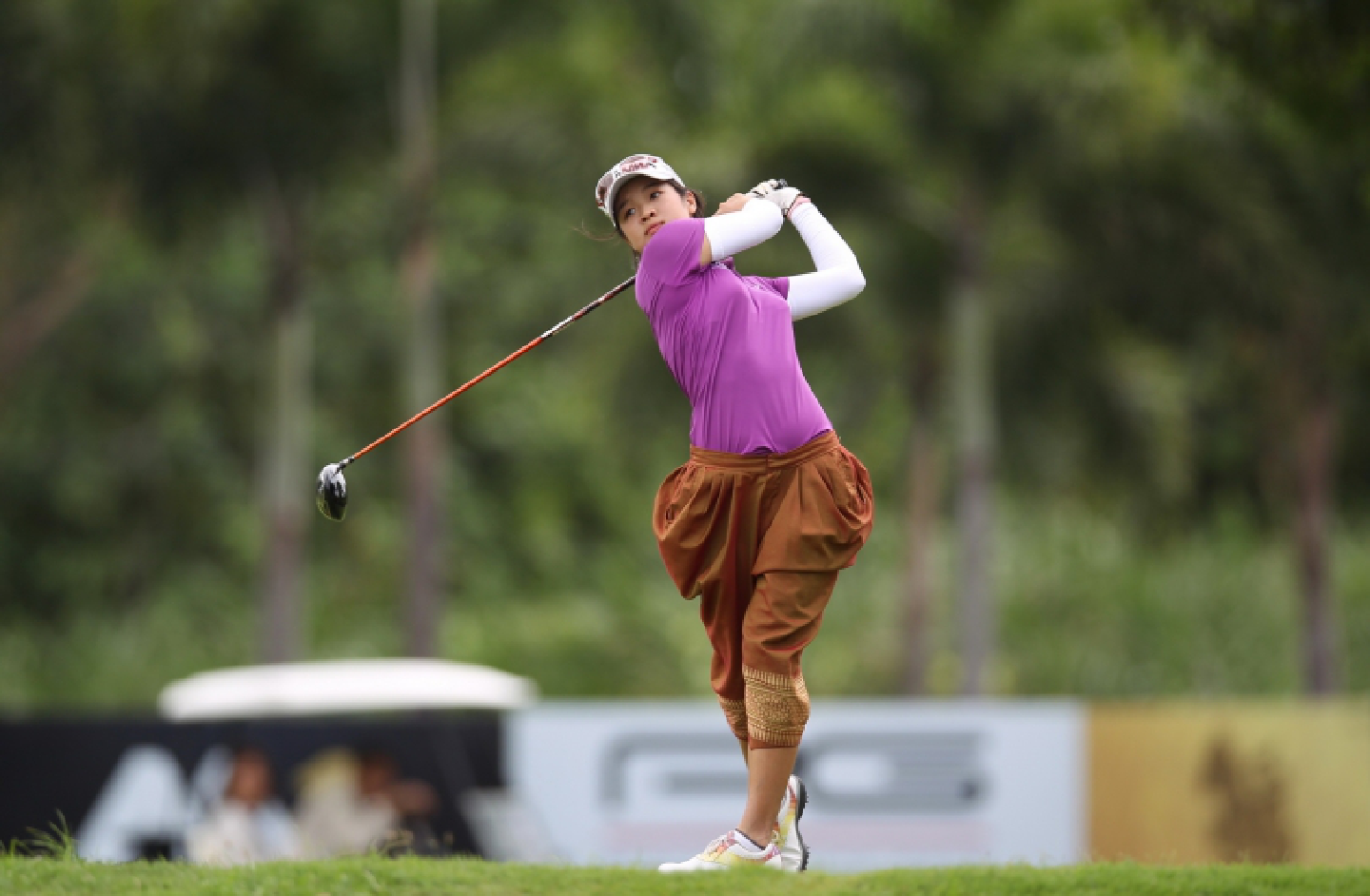 Chalisa Limpipolpaibul plays golf with a traditional outfit. Chalisa Limpipolpaibul plays golf with a traditional outfit.