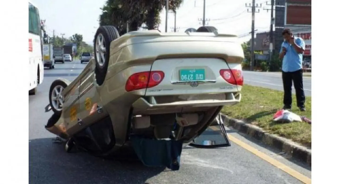 Taxi flips on main Phuket thoroughfare Taxi flips on main Phuket thoroughfare