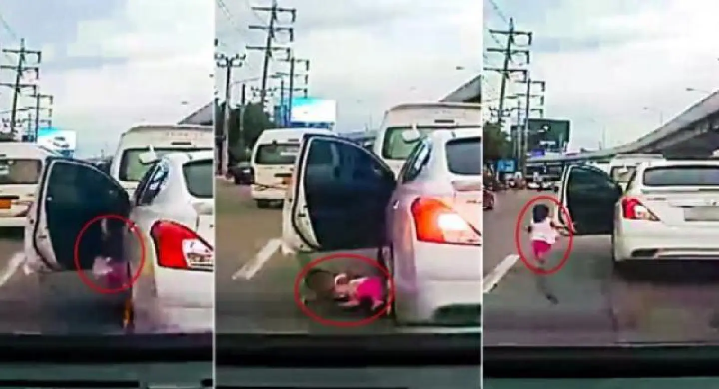 Shocking moment Thai toddler falls from car and narrowly avoids being crushed to death Shocking moment Thai toddler falls from car and narrowly avoids being crushed to death
