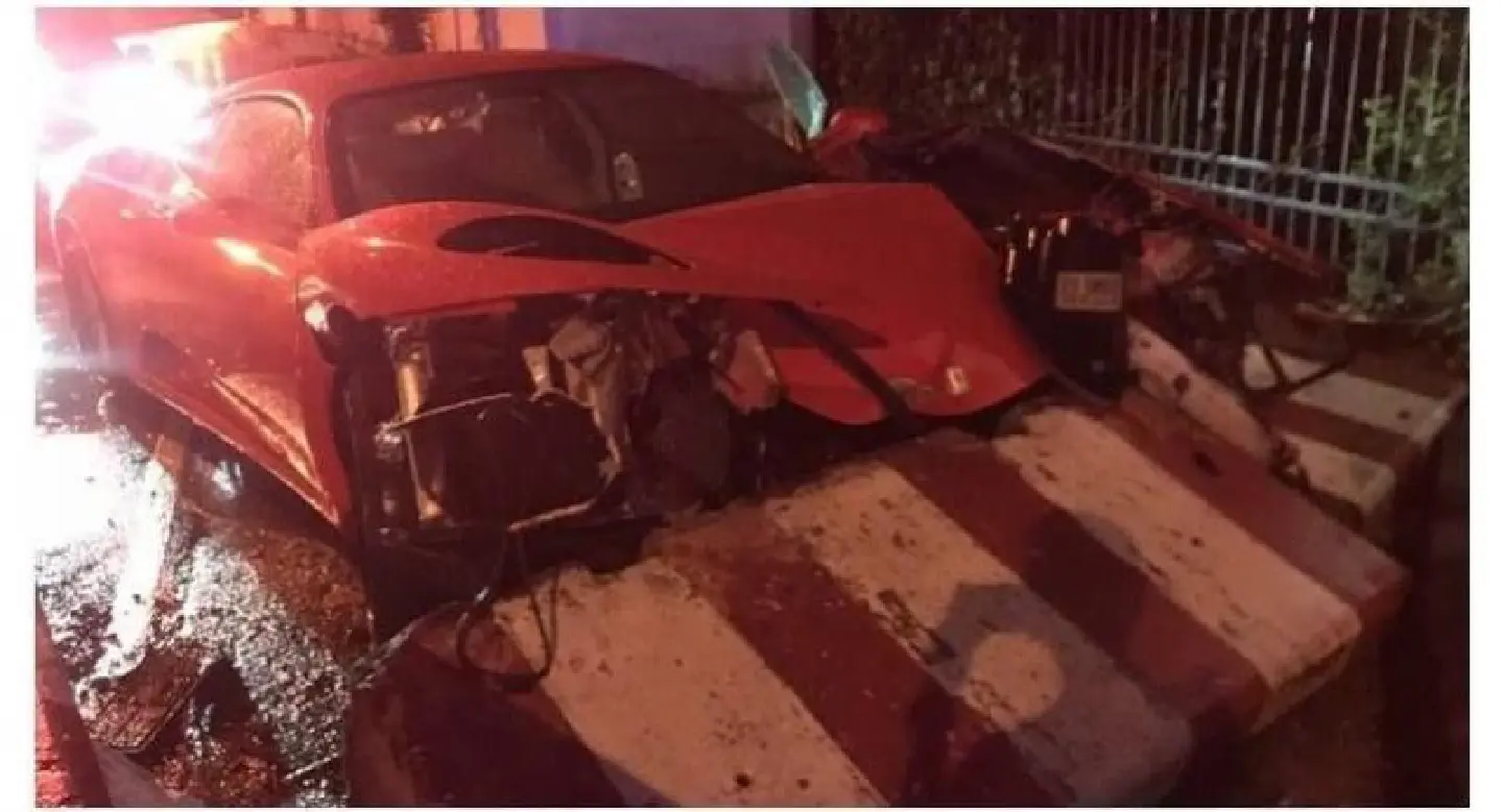 Woman slightly injured as Ferrari rams concrete barrier