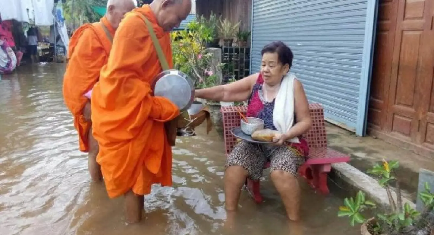 Monks negotiate floodwater to accept alms in Phichit Monks negotiate floodwater to accept alms in Phichit