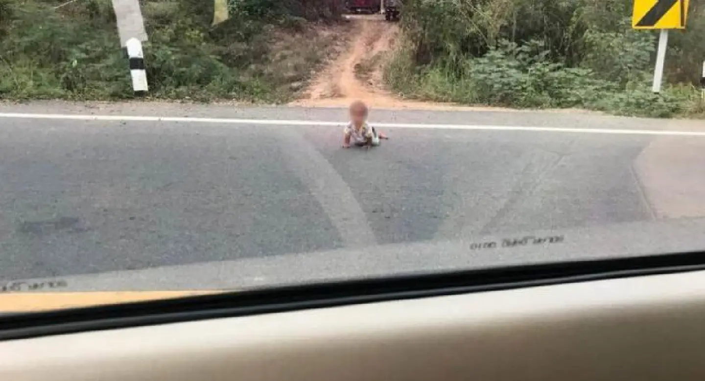Lucky escape for toddler who crawled out into road