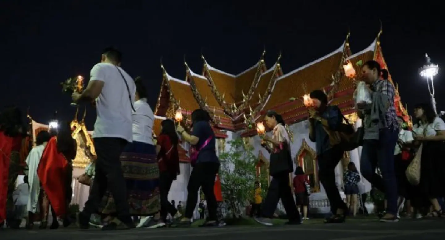Buddhists take part in a candle-lit circumambulation ceremony to mark Makha Bucha Day