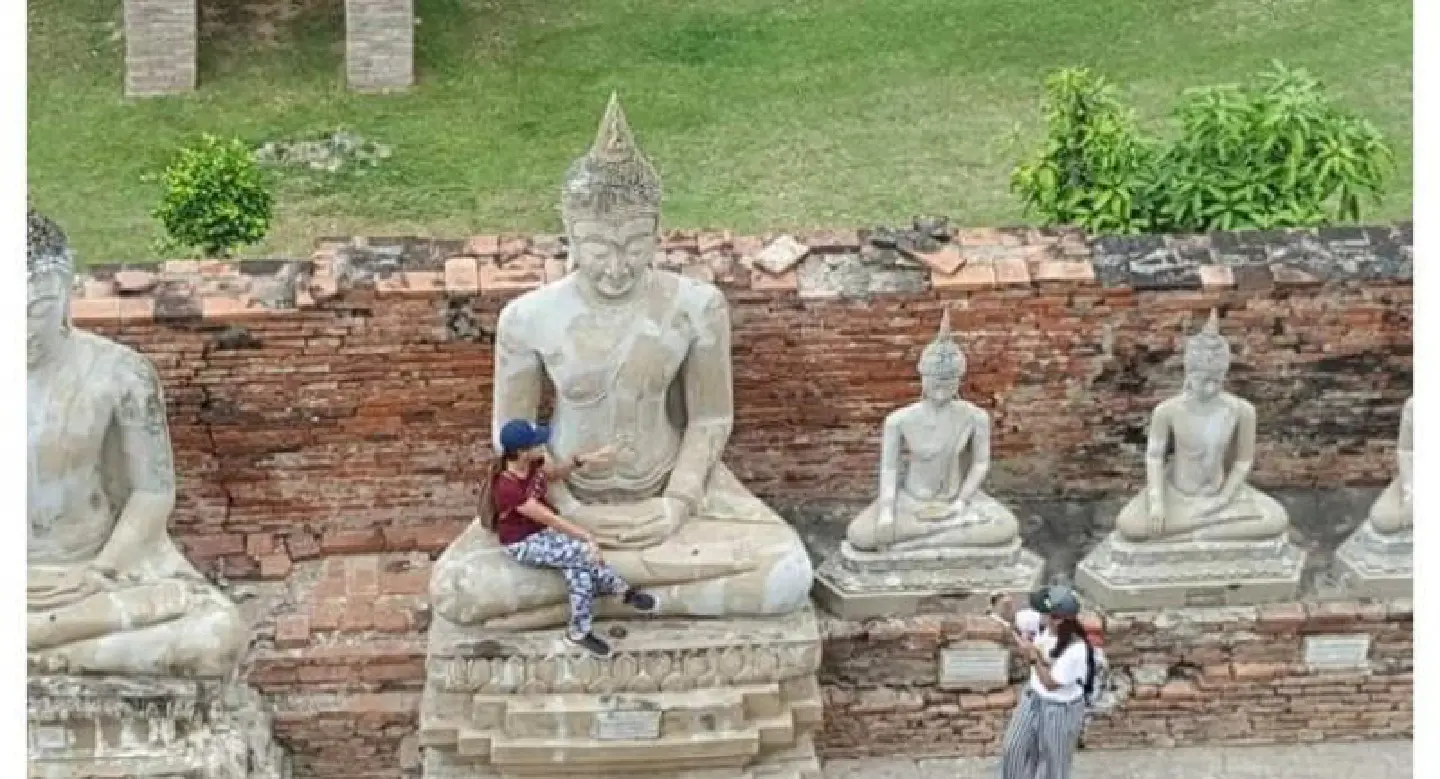 Facebook uproar over woman sitting in Ayutthaya Buddha’s lap