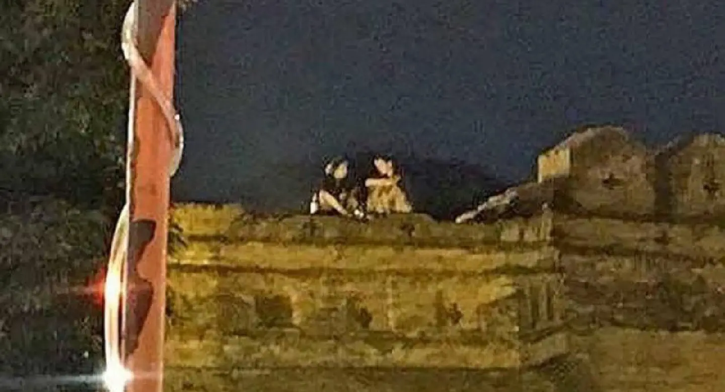 Foreign couple photographed drinking  atop historic Chiang Mai wall