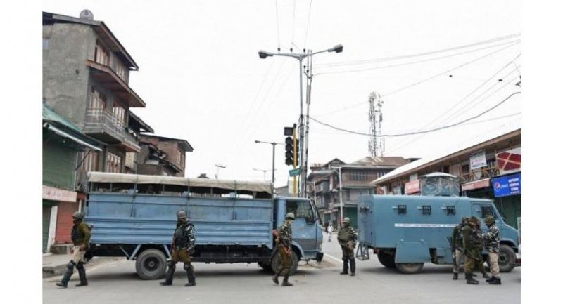 Indian paramilitary troopers stand guard as they block a road in Srinagar on March 1.//AFP