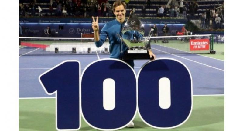 Switzerland's Roger Federer celebrates with the trophy after winning the final match. / AFP