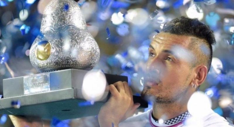 Australian tennis player Nick Kyrgios holds the trophy after defeating German tennis player Alexander Zverev.