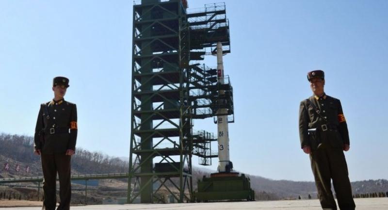 This file photo taken on April 8, 2012 shows two North Korean soldiers standing guard in front of the Unha-3 rocket at at the Sohae Satellite Launch Station in Tongchang-Ri.//AFP