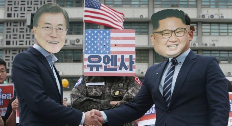 South Korean protesters wearing a mask of South Korean president Moon Jae-in (L) and North Korean leader Kim Jong-un (R) during a rally against US and South Korean government military policies in Seoul on April 26.//EPA-EFE