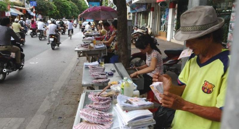 In a picture taken on July 16, 2012, vendors display lottery tickets for sale in Hanoi. //AFP