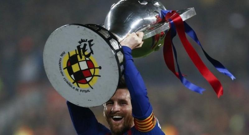 Lionel Messi celebrates with the Liga trophy as Barcelona won their 26th league title after the Spanish League football match between Barcelona and Levante at the Camp Nou stadium in Barcelona.
