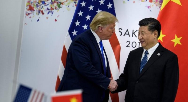 China's President Xi Jinping (R) greets US President Donald Trump before a bilateral meeting on the sidelines of the G20 Summit in Osaka on June 29, 2019. (Photo by Brendan Smialowski / AFP)