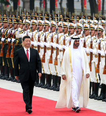 President Xi Jinping and Sheikh Mohammed bin Zayed Al Nahyan, crown prince of Abu Dhabi of the United Arab Emirates, inspect an honor guard in Beijing on Monday. [Photo by Feng Yongbin / China Daily]