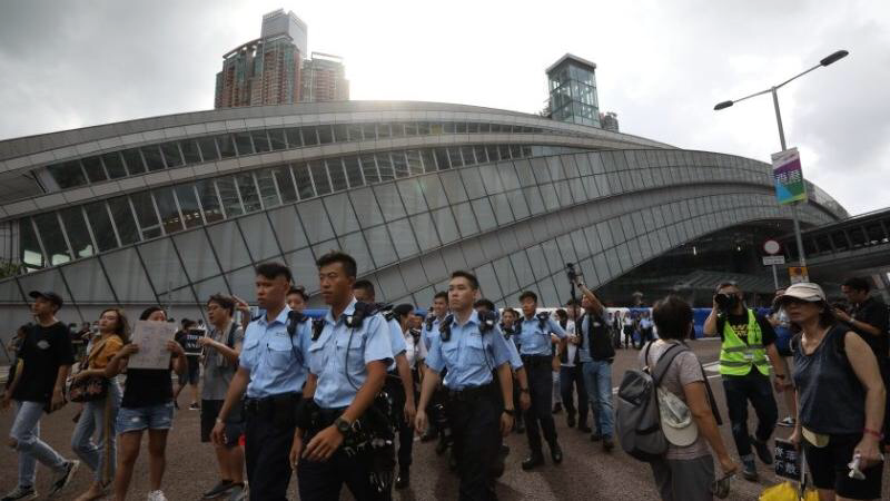 This photo shows police officers near the West Kowloon Station ahead of a protest procession, July 7, 2019. (CALVIN NG / CHINA DAILY)