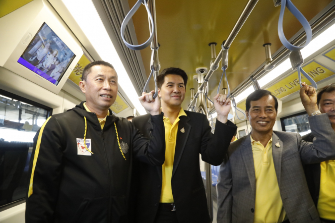 Transport Minister Saksyam Chidchob, left,  poses on Thursday with his deputies Athirat Rattanaset, centre, and Thavorn Senniam during a trial run of a newly launched underground train in a short trip from Sanam Chai to Tha Phra station.