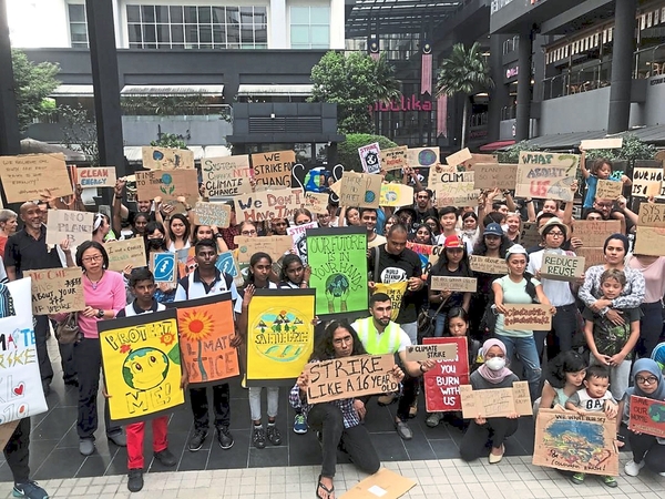Taking a stand: Protestors, young and old, holding up placards demanding for urgent government action on climate change during a climate strike in Kuala Lumpur yesterday.-Photo by The Star