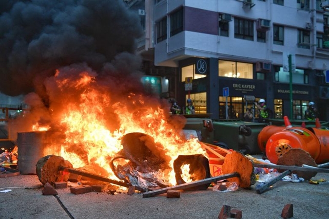 Hong Kong police fire tear gas at protesters marching ahead of China's 70th birthday bash Hong Kong police fire tear gas at protesters marching ahead of China's 70th birthday bash