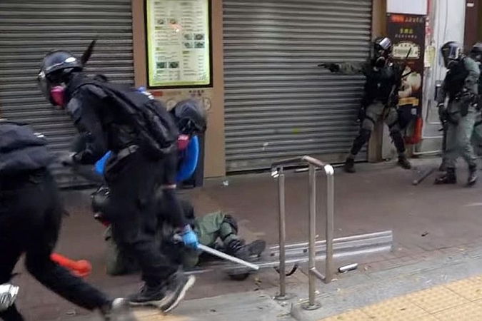 The police officer who was initially attacked lies on the ground.PHOTO: CAMPUS TV, HONG KONG UNIVERSITY STUDENTS' UNION