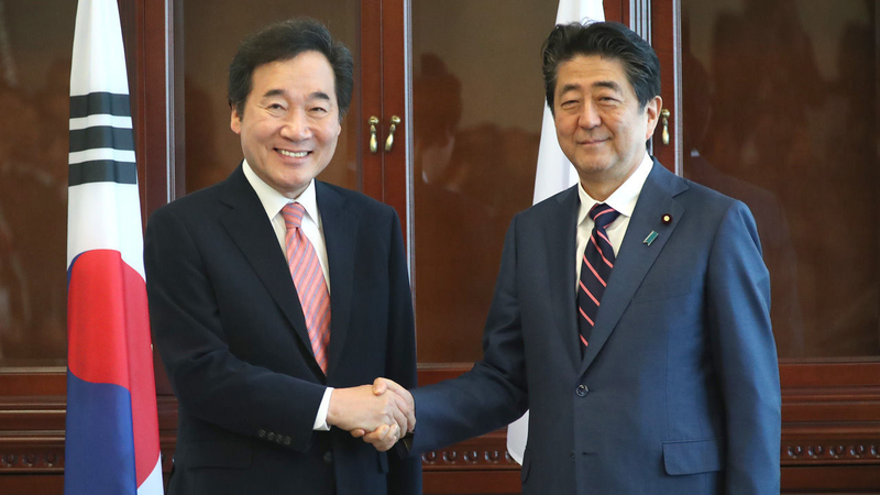 Prime Minister Lee Nak-yeon shakes hands with the Japanese Prime Minister Shinzo Abe. Photo Credit: Yonhap