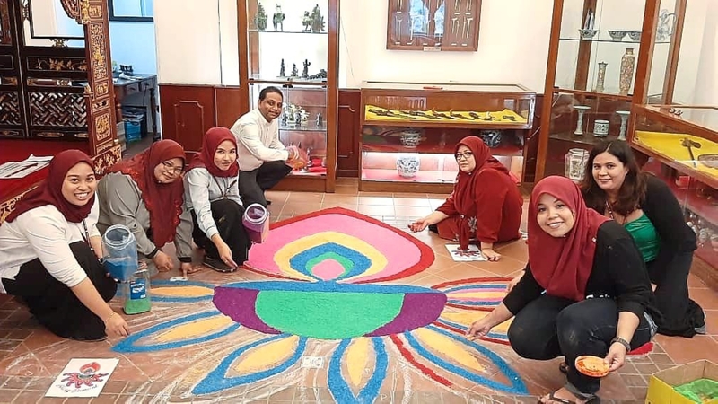 Festive preparations: Samford (fourth from left) with his staff members, who designed a kolam at Shah Beach Resort in Melaka.