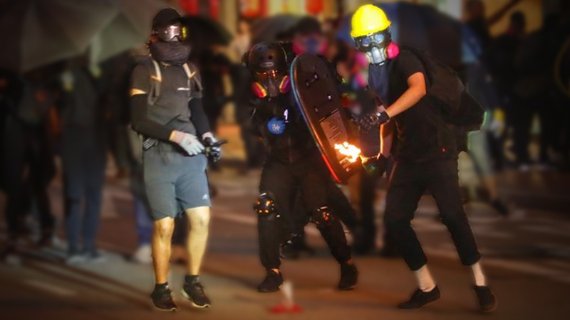 A rioter throws a gasoline bomb at police in Wan Chai. [PHOTO/CHINA DAILY]