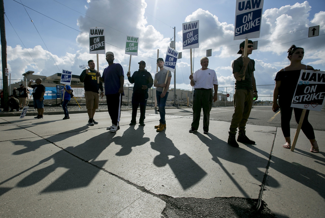 Demonstrators holds signs reading 