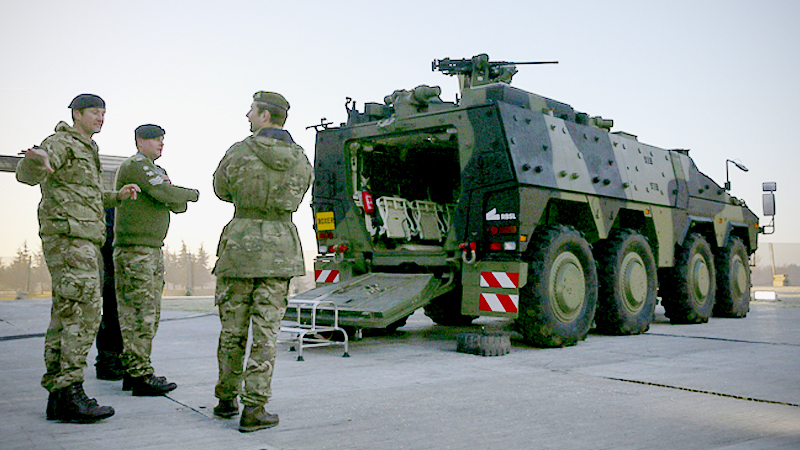 Soldiers stand guard near an armored vehicle on the perimeter of the NATO leaders' meeting near Watford, England, on Dec. 4, 2019. MUST CREDIT: Bloomberg photo by Hollie Adams.