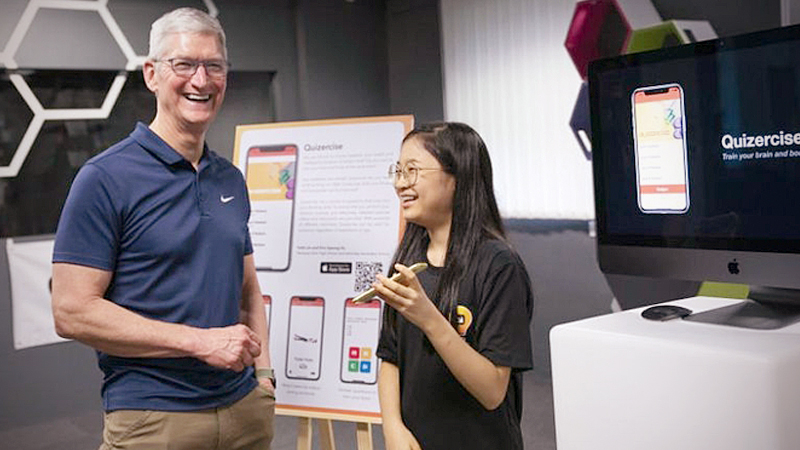 Apple chief executive officer Tim Cook, alongside Quizercise co-creator Faith Lim. Faith is one of the 100 graduates of Apple’s Swift Accelerator coding programme.PHOTO: APPLE