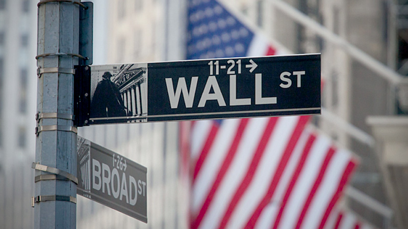 A Wall Street street sign hangs in front of the New York Stock Exchange in New York on May 25, 2018. MUST CREDIT: Bloomberg photo by Michael Nagle.
