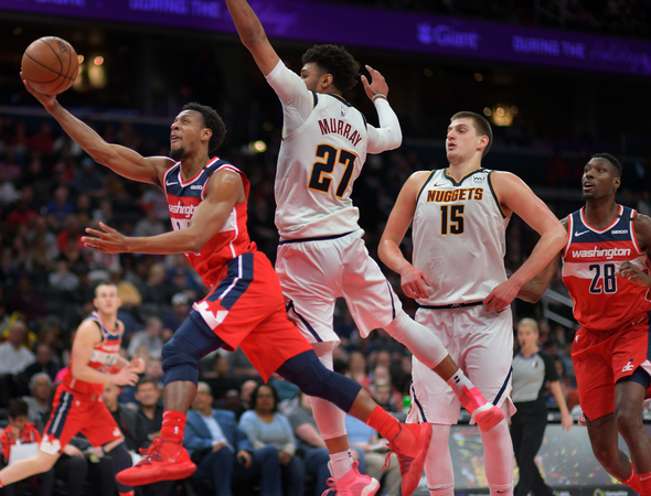 Wizards guard Ish Smith (14) drives past Nuggets guard Jamal Murray (27) and center Nikola Jokic (15) for a basket in Saturday night's game at Capital One Arena in Washington, D.C. MUST CREDIT: Washington Post photo by John McDonnell