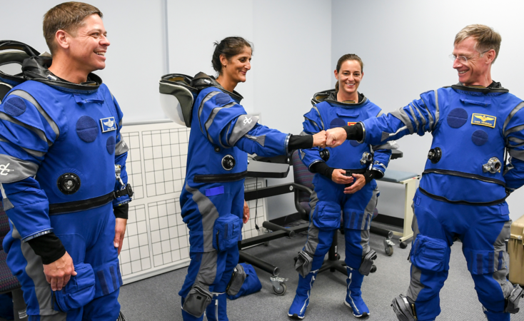 Chris Ferguson, Boeing director of Starliner Crew and Mission Systems and a former NASA astronaut, fist bumps NASA commercial crew astronaut Suni Williams as Nicole Mann and Bob Behnken prepare for emergency egress system training at Kennedy Space Center. MUST CREDIT: Photo for The Washington Post by Jonathan Newton