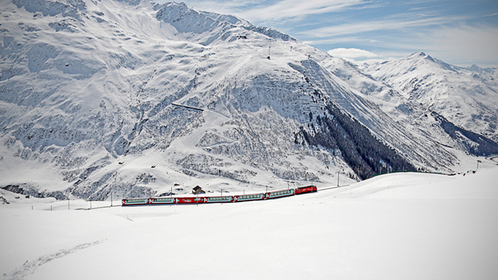 The Glacier express makes it's way across a snowy landscape. MUST CREDIT: Glacier Express AG.