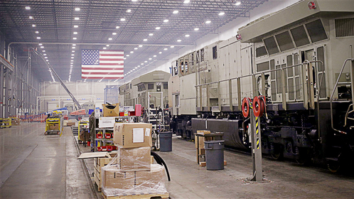 An American flag hangs as General Electric diesel locomotives stand on the final assembly line at the GE Manufacturing Solutions facility in Fort Worth, Texas, on Oct. 25, 2016. MUST CREDIT: Bloomberg photo by Luke Sharrett.
