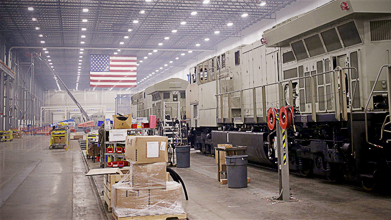 An American flag hangs as General Electric diesel locomotives stand on the final assembly line at the GE Manufacturing Solutions facility in Fort Worth, Texas, on Oct. 25, 2016. MUST CREDIT: Bloomberg photo by Luke Sharrett.
