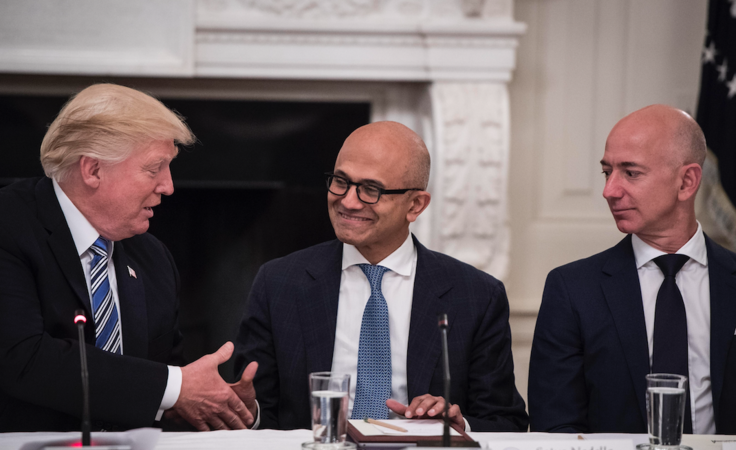 President Donald Trump greets Satya Nadella, chief executive of Microsoft, and Jeff Bezos, chief executive of Amazon and owner of The Washington Post, during an American Technology Council roundtable in June 2017. MUST CREDIT: Washington Post photo by Jabin Botsford
