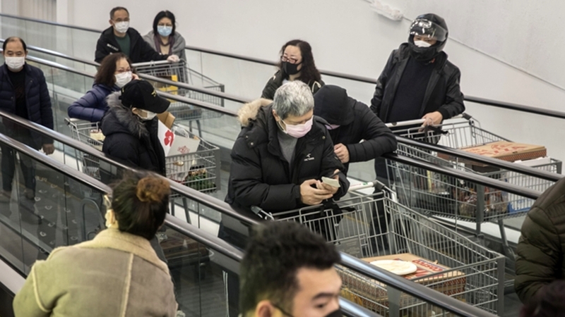 Shoppers move through a supermarket in Shanghai on Feb. 14, 2020. MUST CREDIT: Bloomberg photo by Qilai Shen.