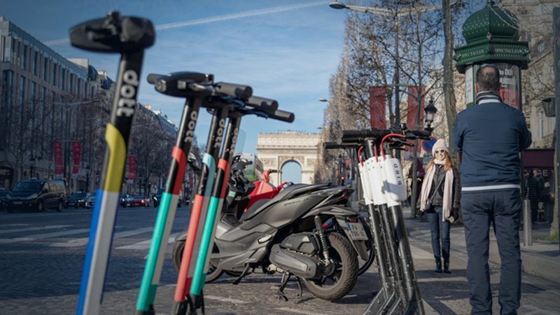 Tourists pose for photographs beside Dott and Bird Rides Inc.public hire scooters in Paris on Dec. 31, 2019. MUST CREDIT: Bloomberg photo by Anita Pouchard Serra.

