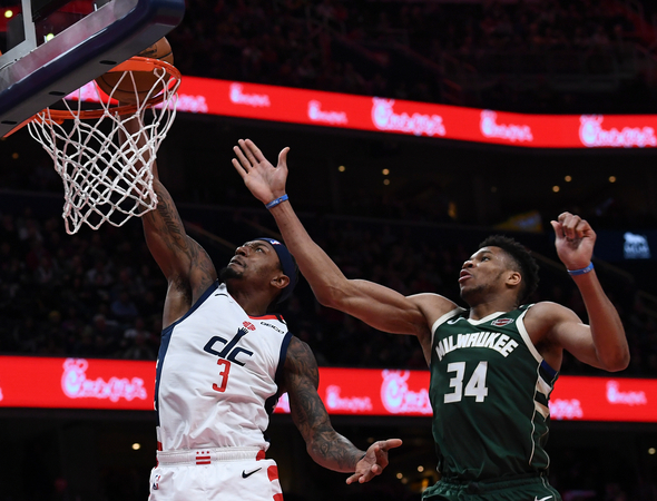 Bradley Beal beats Giannis Antetokounmpo to the rim Monday, Feb. 24, 2020. MUST CREDIT: Washington Post photo by Toni L. Sandys