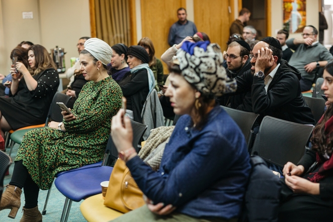 Members of Israel's ultra-Orthodox Jewish community listen to representatives from several political parties ahead of next week's national election. (MUST CREDIT: David Vaaknin/For The Washington Post).