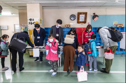 Parents check in their children March 5, 2020, at Kitaurawa Elementary School in Japan's Saitama prefecture. The school lets their students use its rooms to study on their own, an alternative offered by some institutions after Japan ordered all schools closed to prevent the spread of coronavirus. MUST CREDIT: Photo for The Washington Post by Shiho Fukada