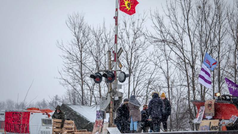 Demonstrators stand near railway tracks during a protest Feb. 13, 2020, near Belleville, Ontario, Canada. MUST CREDIT: Bloomberg photo by Brett Gundlock