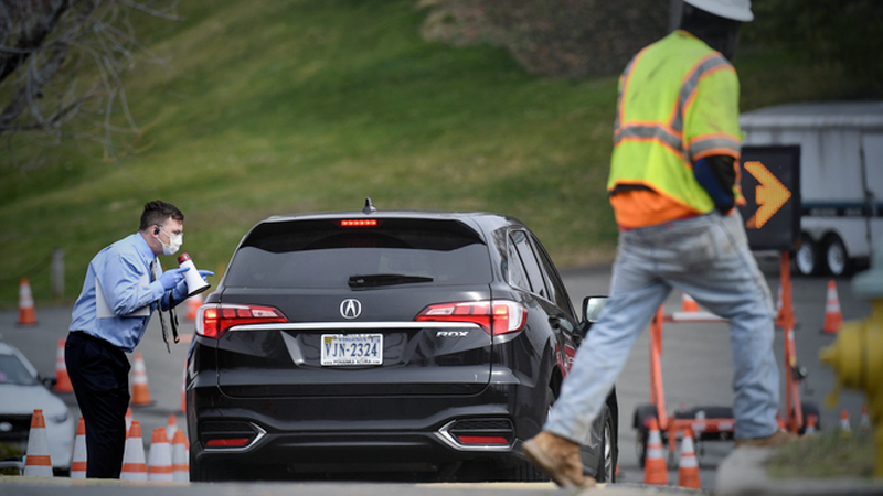 A health-care worker confirms a driver's appointment at a drive-through sample-collection site in Arlington, Virginia, on Wednesday, March 18, 2020. MUST CREDIT: Washington Post photo by Toni L. Sandys