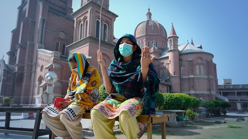 Women wearing masks pray outside Lahore's Sacred Heart Cathedral, one of the churches that has been closed down to discourage large congregations | M Arif, White Star