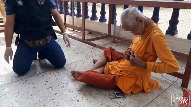 Elderly monk caught stealing donated money Elderly monk caught stealing donated money
