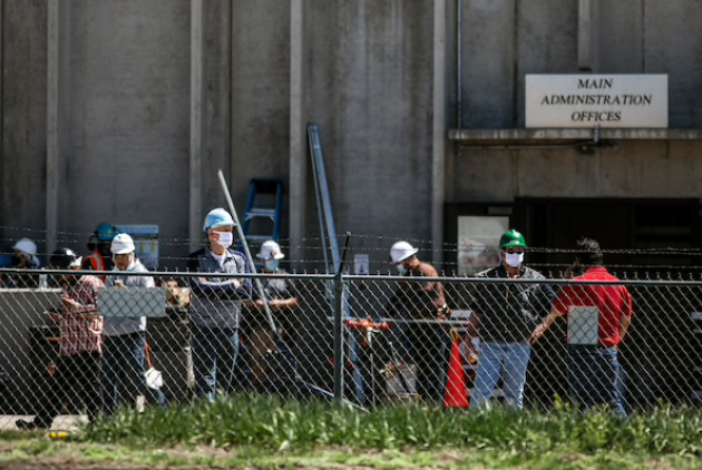 Workers wait outside of the JBS meat processing plan in Greeley, Colo., on Monday, April 27, 2020. MUST CREDIT: Photo for The Washington Post by Chet Strange
