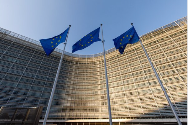 Flags of the European Union fly outside the Berlaymont building, which houses offices of the European Commission, in Brussels, Belgium, on March 26, 2020. MUST CREDIT: Bloomberg photo by Olivier Matthys.