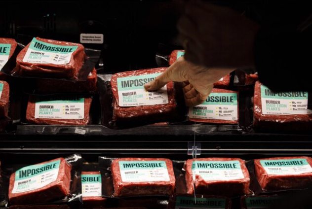A customer picks up a package of Impossible Burger plant-based meat at Gelson's Markets in Los Angeles on Sept. 20, 2019. MUST CREDIT: Bloomberg photo by Patrick T. Fallon.

